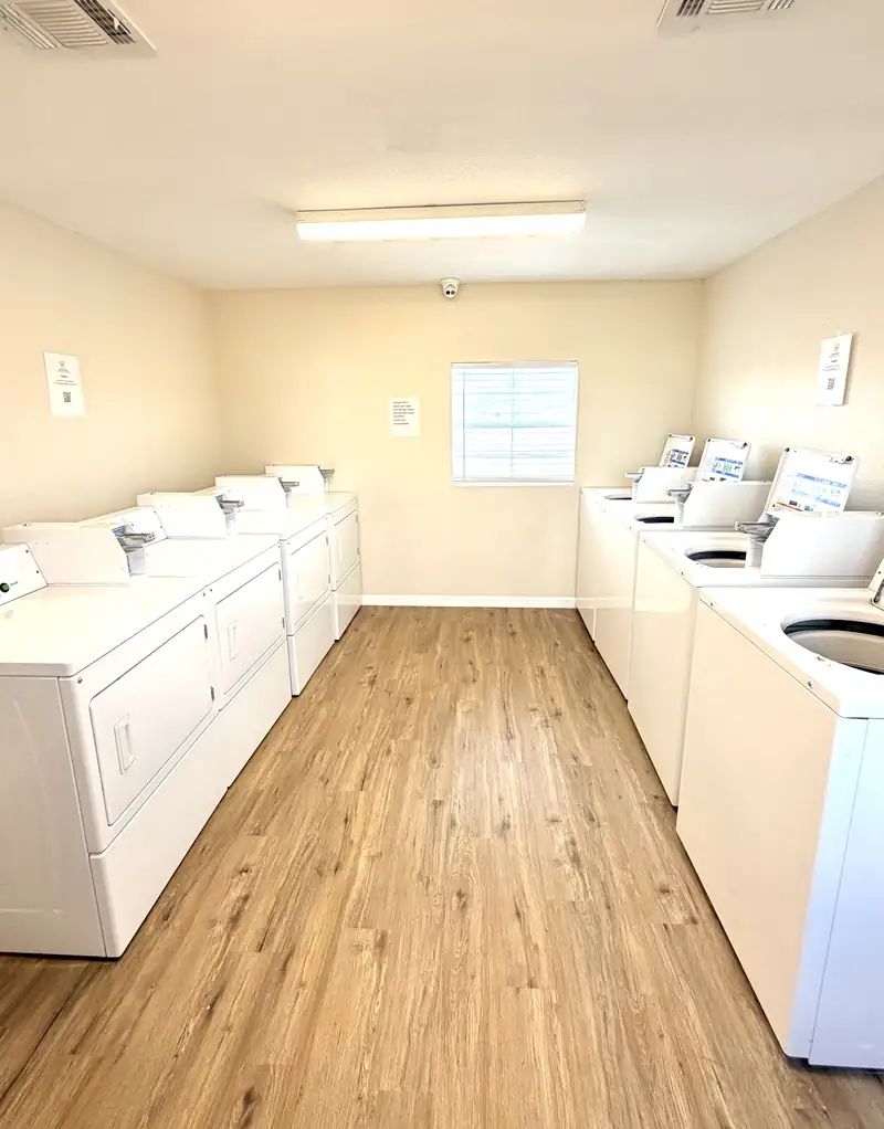 Interior of the on-site laundry facility with washers and dryers